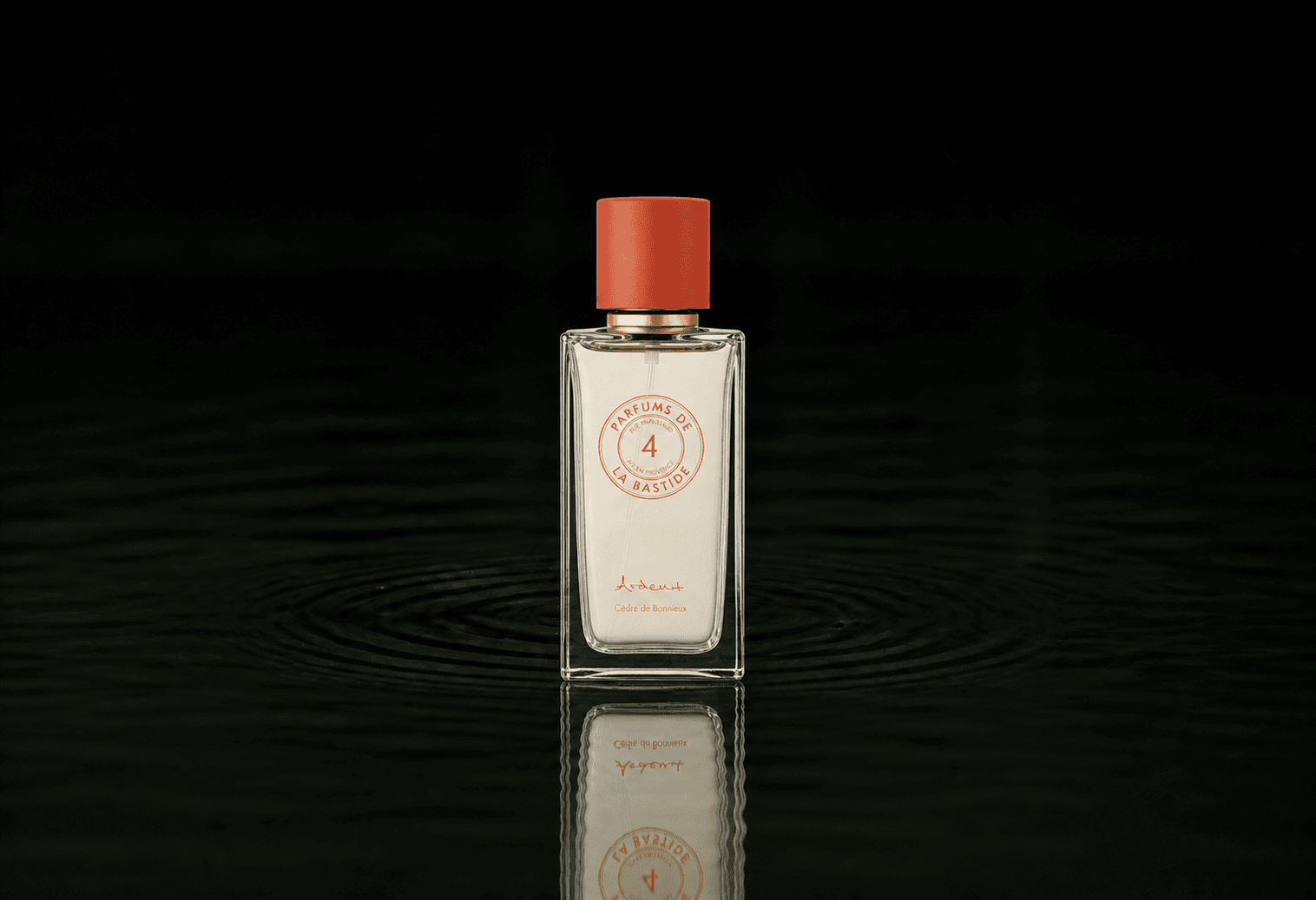 Bastide Ardent fragrance bottle floating above dark water