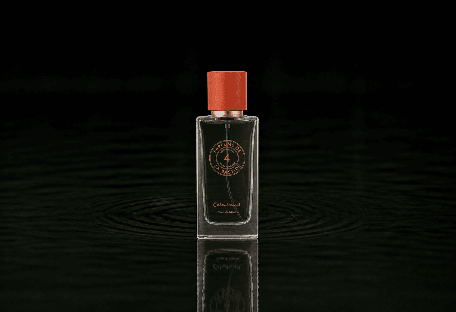 Bastide Eclatant fragrance bottle floating above dark water