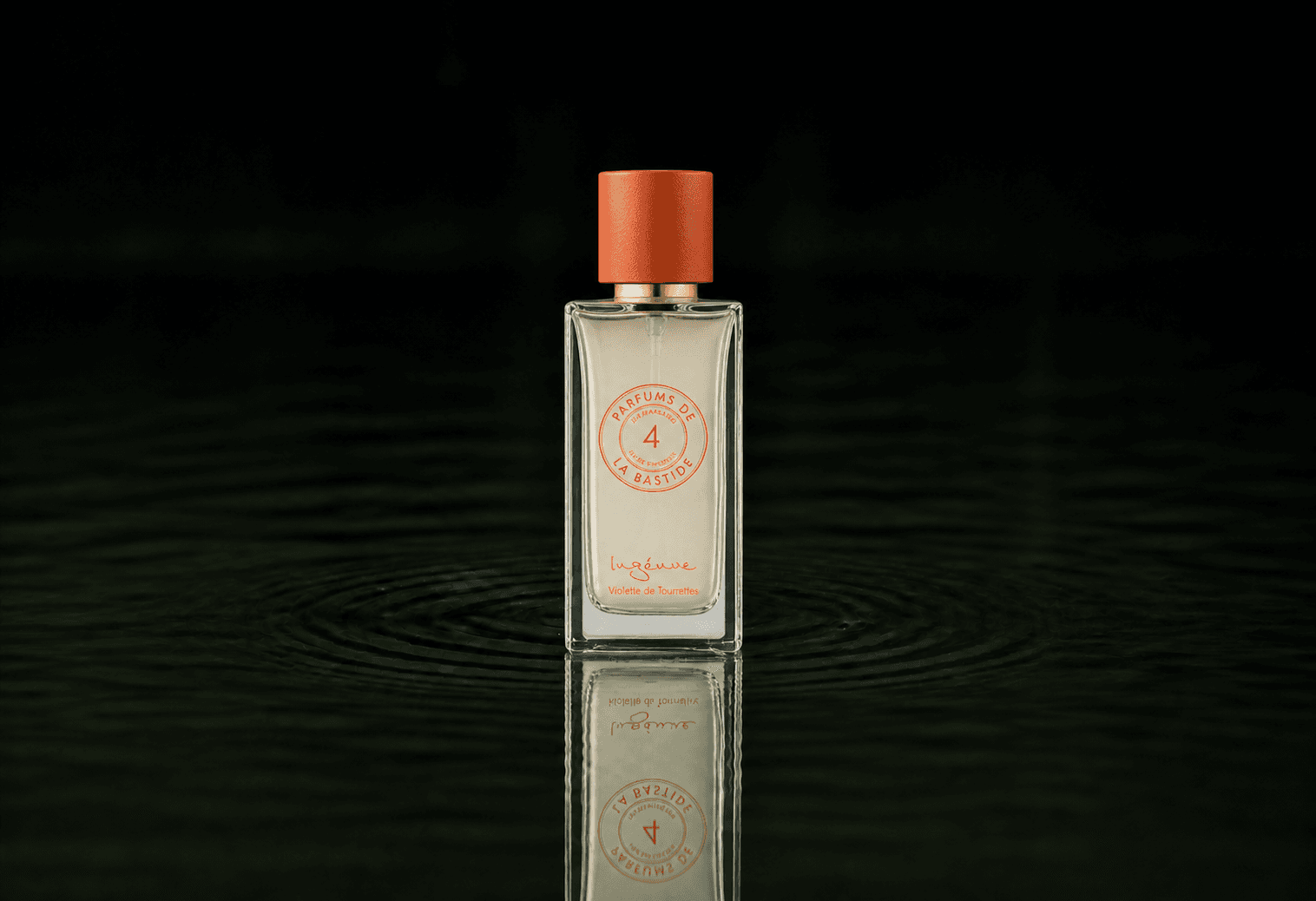 Bastide Ingenue fragrance bottle floating above dark water
