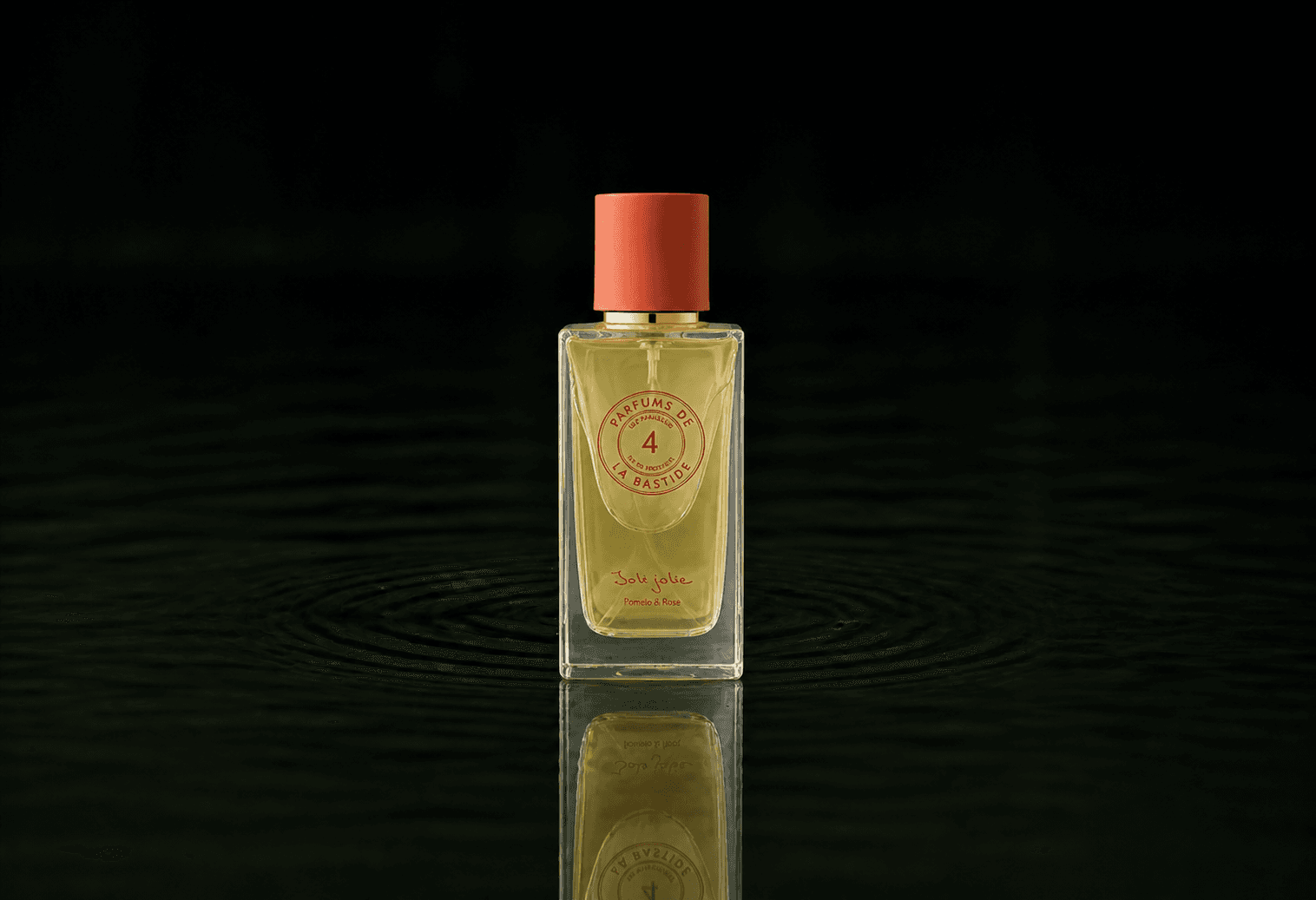 Bastide Insolite fragrance bottle floating above dark water