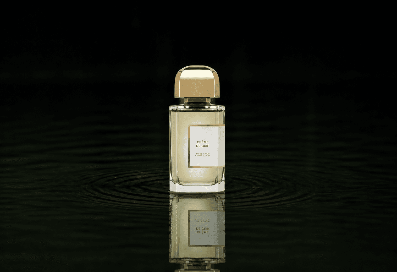 BDK Parfums BDK - Creme De Cuir fragrance bottle floating above dark water