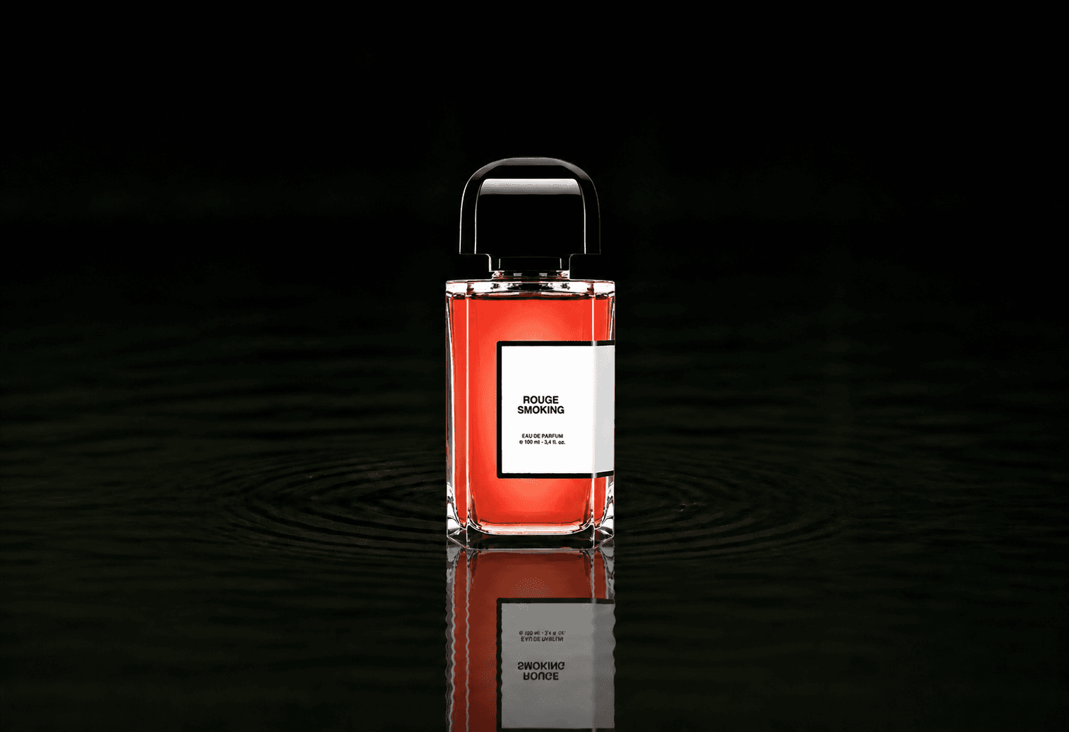 BDK Parfums Rouge Smoking fragrance bottle floating above dark water