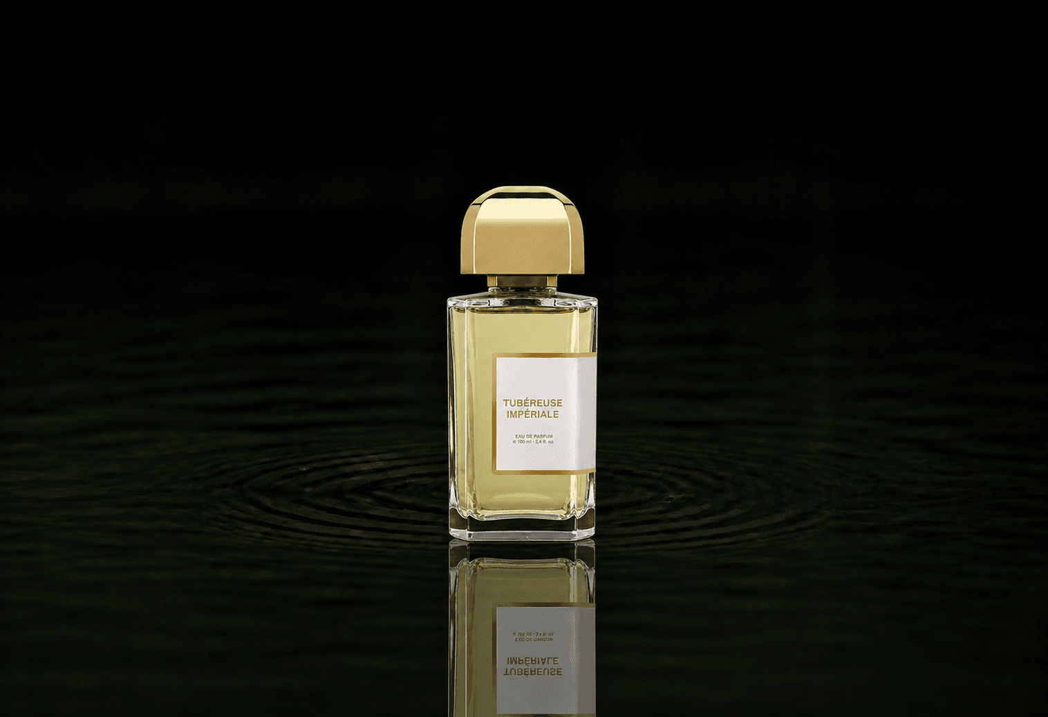 BDK Parfums Tubereuse Imperial fragrance bottle floating above dark water