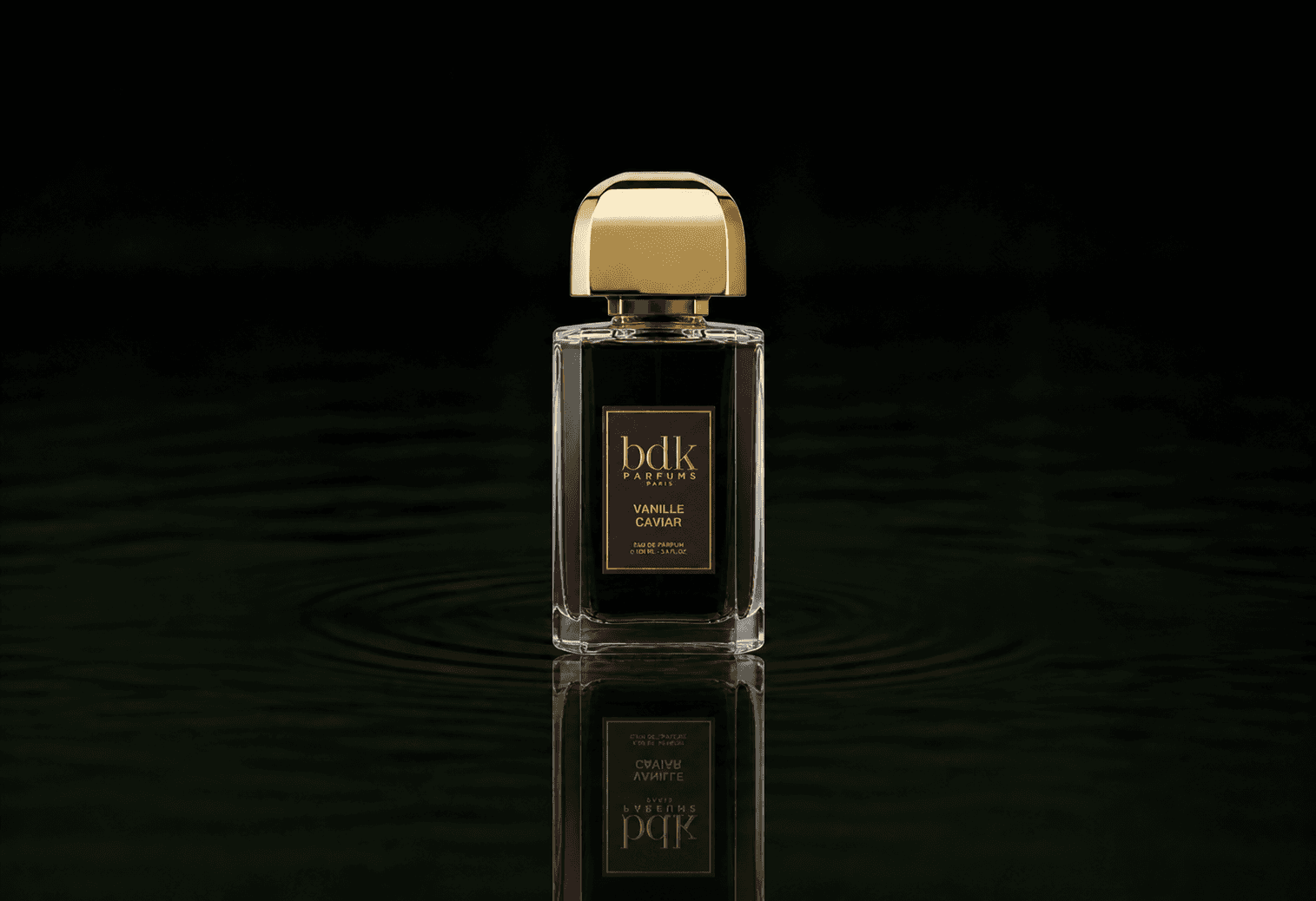 BDK Parfums Vanille Caviar fragrance bottle floating above dark water