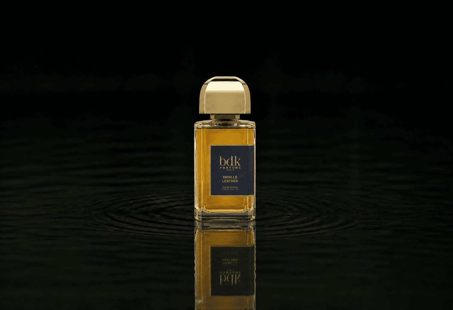 BDK Parfums Vanille Leather fragrance bottle floating above dark water