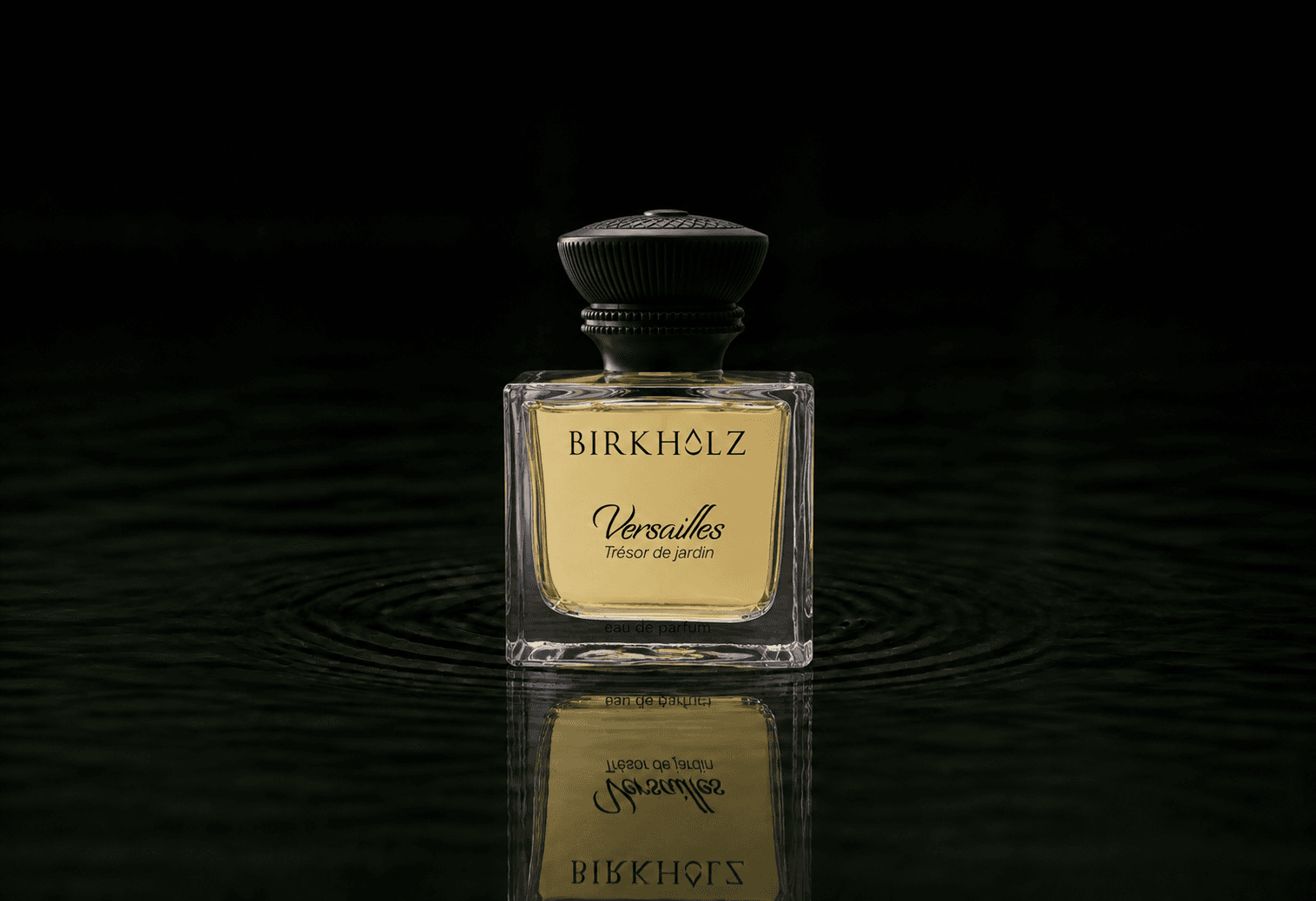 Birkholz Versailles Tresor De Jardin fragrance bottle floating above dark water