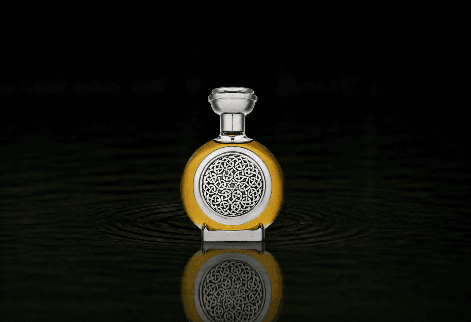 Boadicea The Victorious Elaborate fragrance bottle floating above dark water