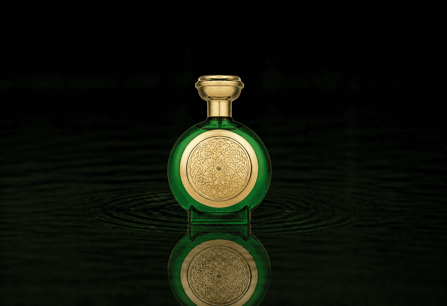 Boadicea The Victorious Green Sapphire parfum fragrance bottle floating above dark water