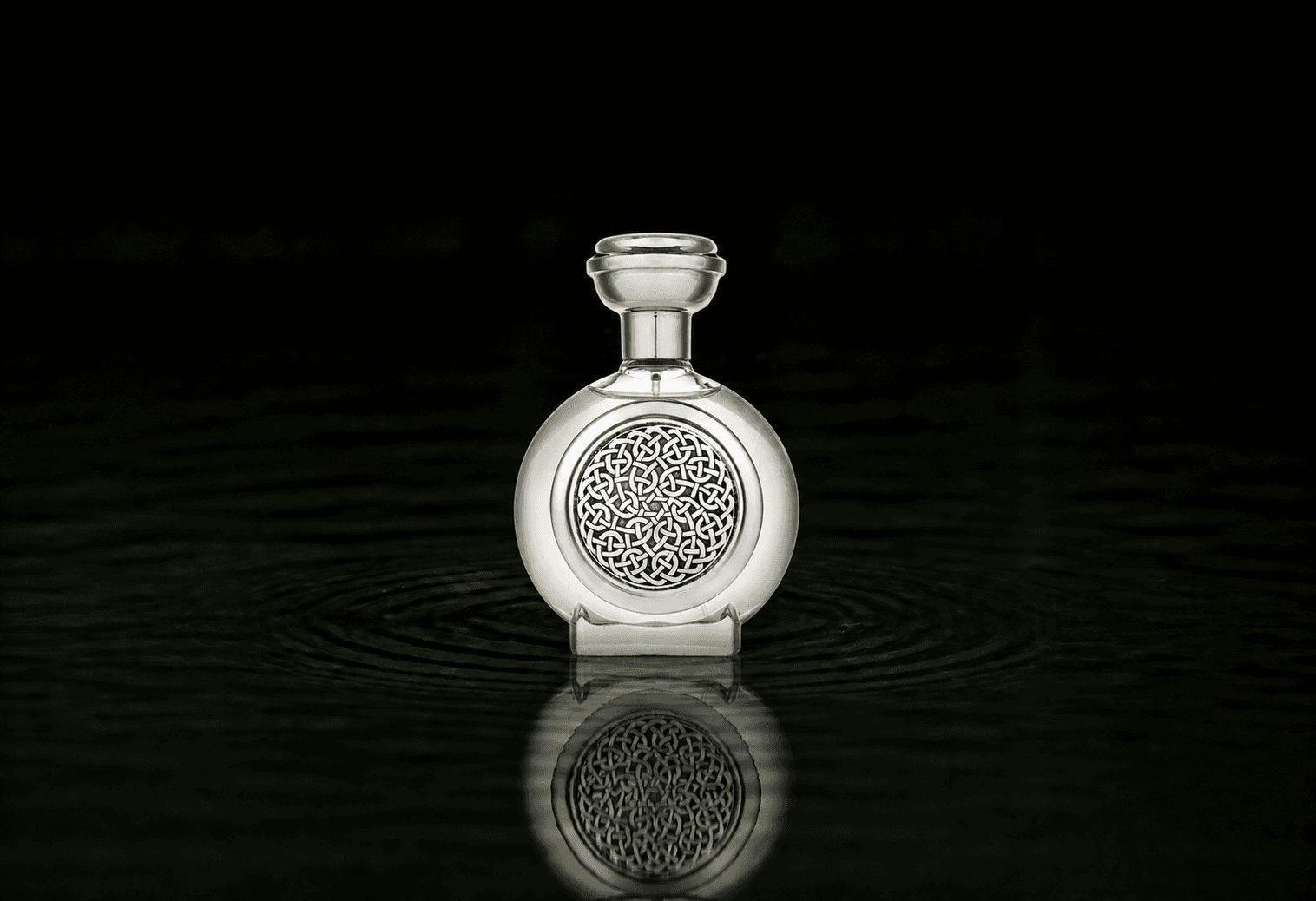 Boadicea The Victorious Monarch fragrance bottle floating above dark water