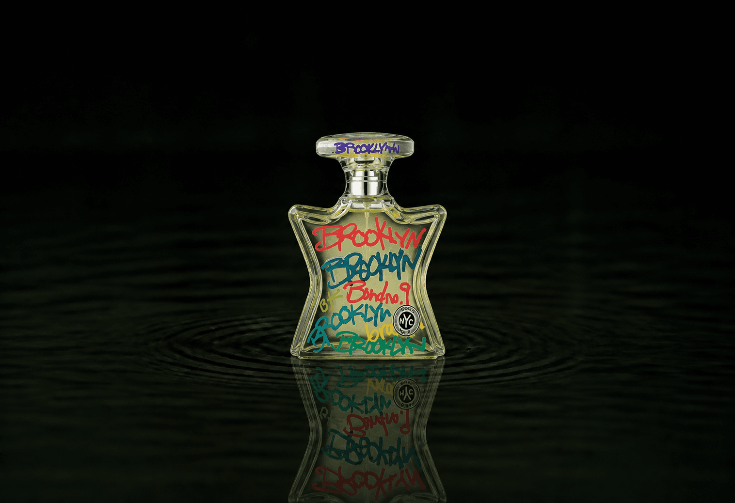 Bond No.9 Brooklyn fragrance bottle floating above dark water