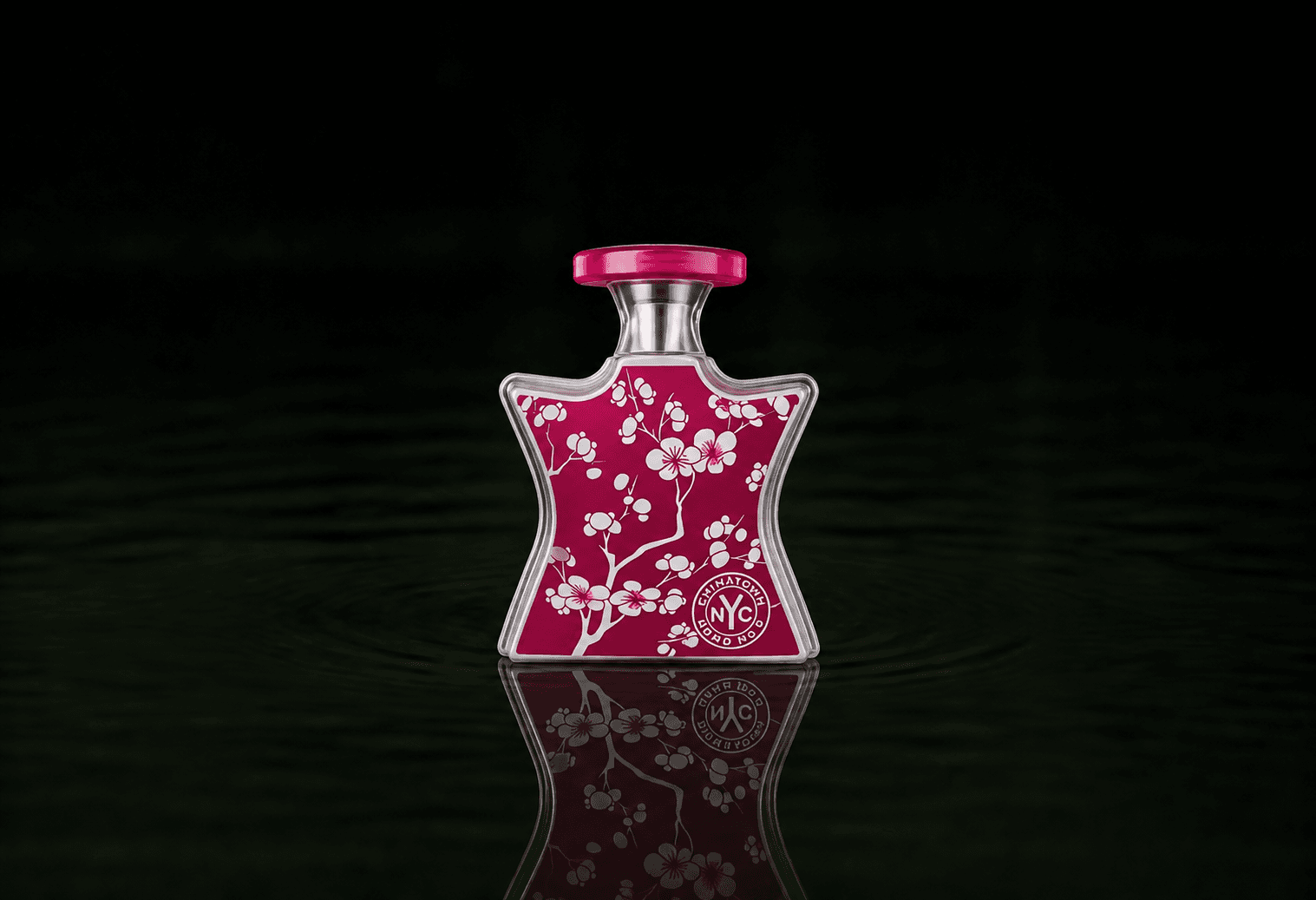 Bond No.9 Chinatown fragrance bottle floating above dark water