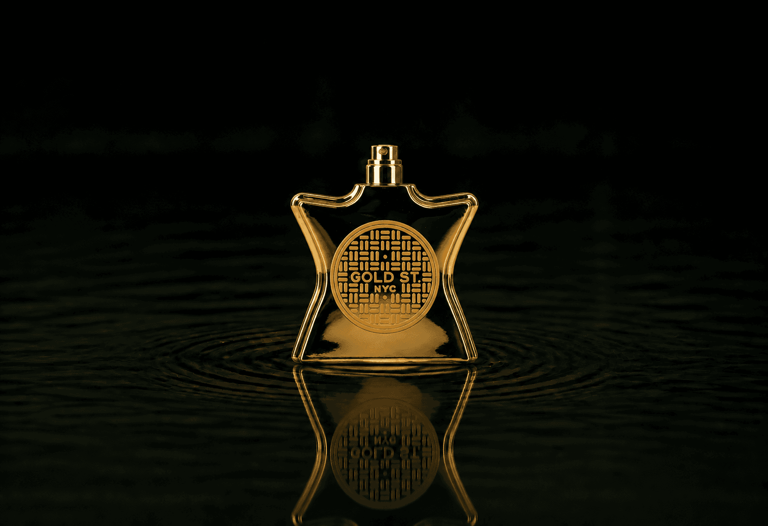 Bond No.9 Gold Street fragrance bottle floating above dark water