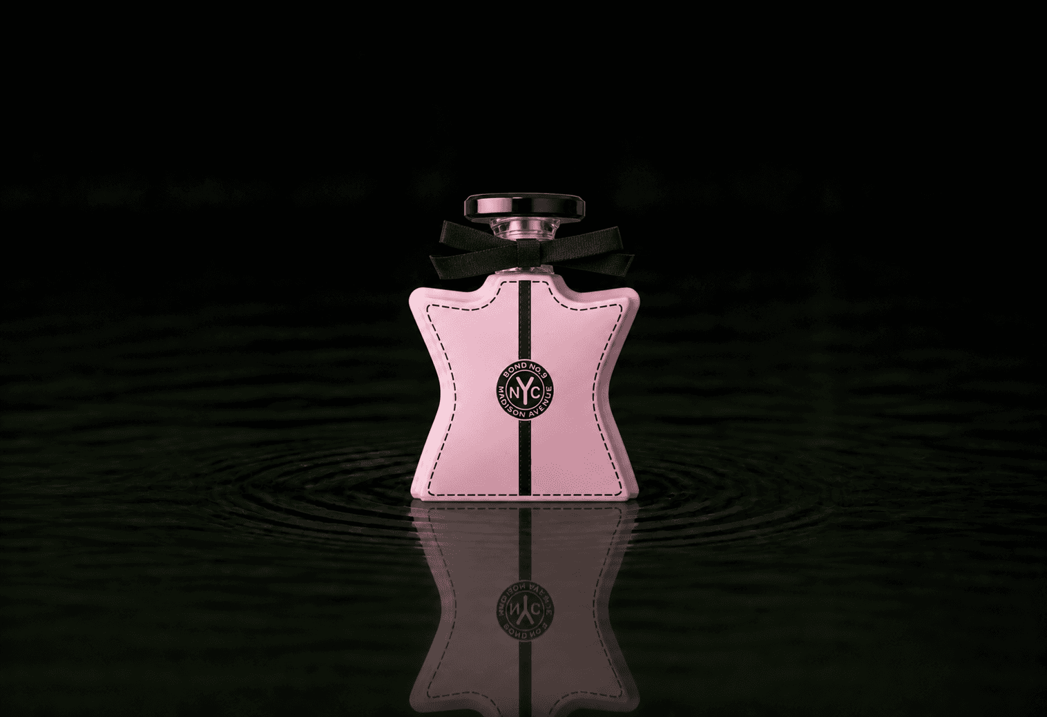 Bond No.9 Madison Avenue fragrance bottle floating above dark water