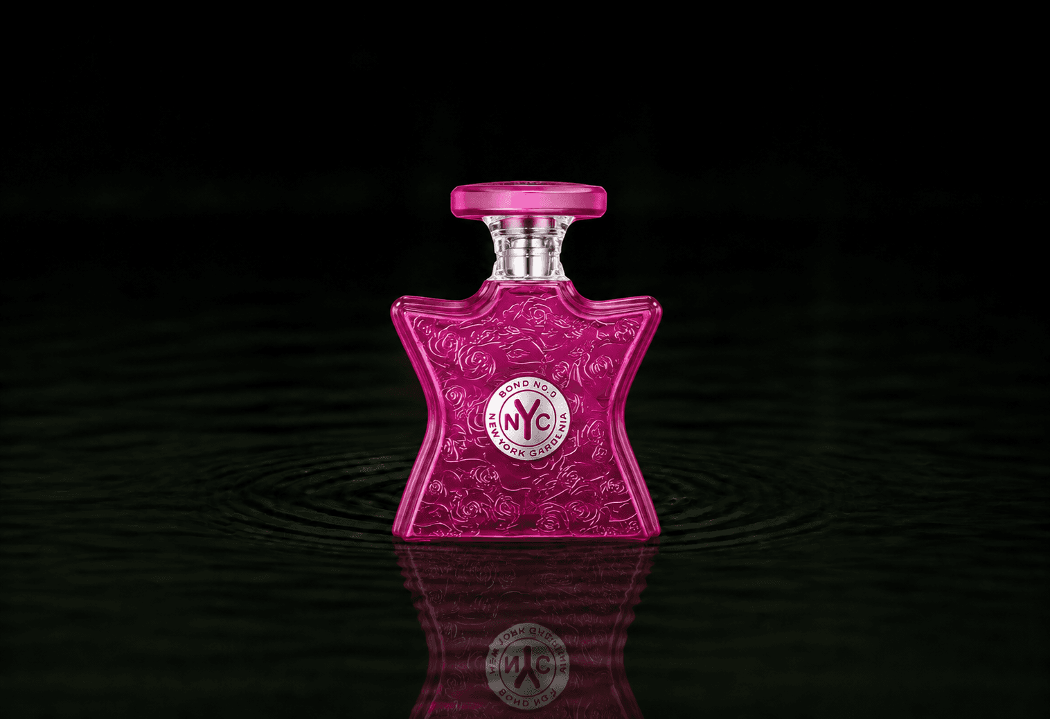 Bond No.9 New York Gardenia fragrance bottle floating above dark water