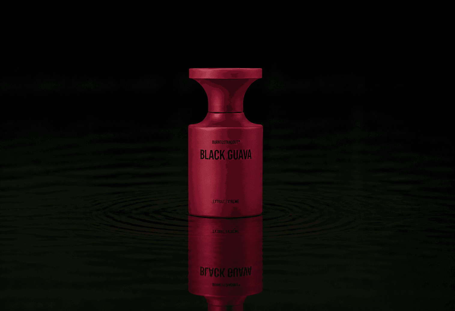 BORNTOSTANDOUT Black Guava - Extrait Extreme fragrance bottle floating above dark water