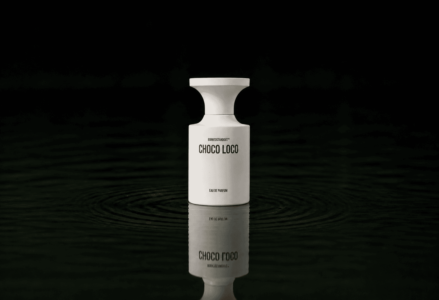 BORNTOSTANDOUT Choco Loco fragrance bottle floating above dark water