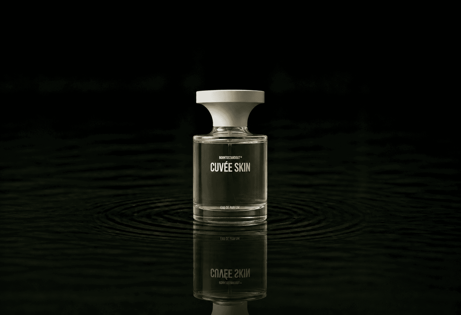 BORNTOSTANDOUT Cuvee Skin fragrance bottle floating above dark water
