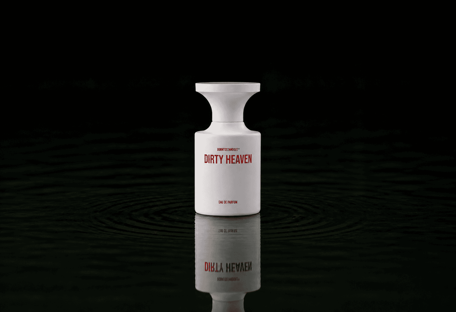BORNTOSTANDOUT Dirty Heaven fragrance bottle floating above dark water