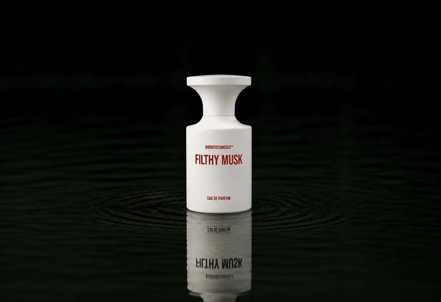 BORNTOSTANDOUT Filthy Musk fragrance bottle floating above dark water