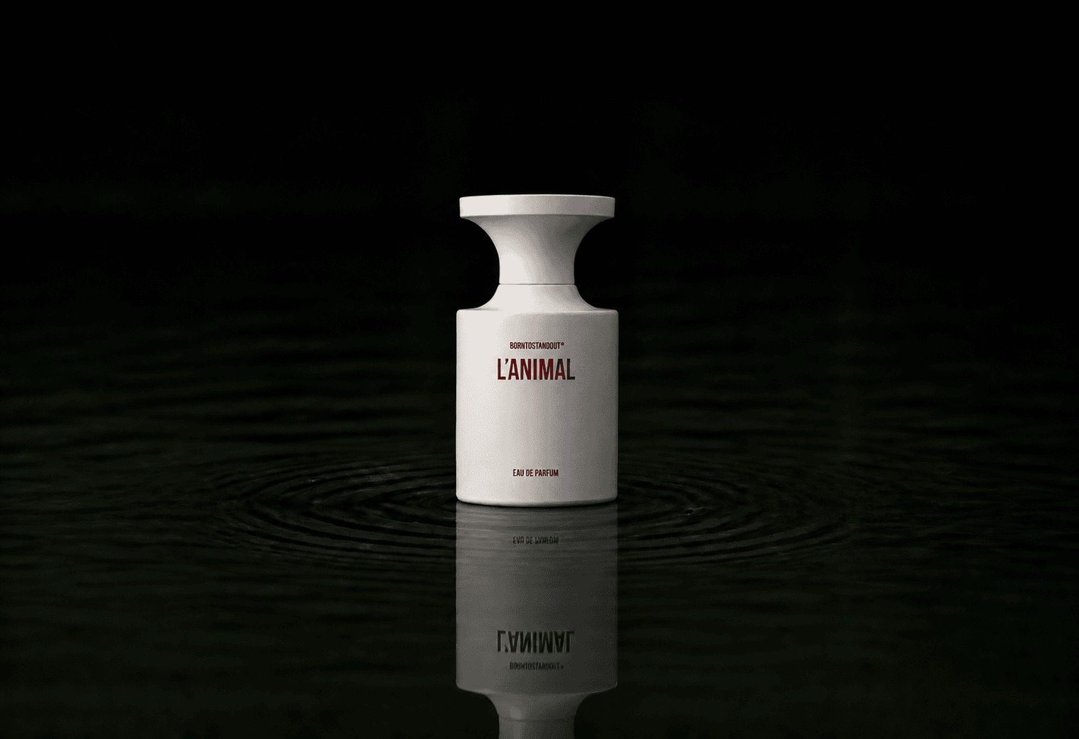 BORNTOSTANDOUT L'Animal fragrance bottle floating above dark water