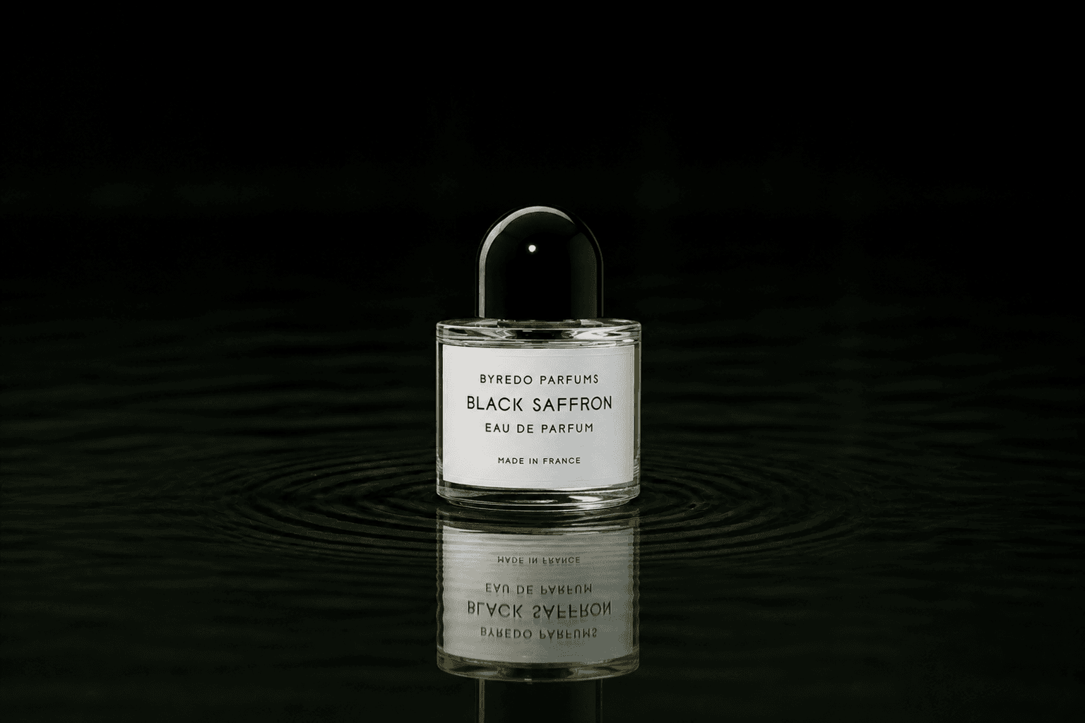 Byredo Parfums - Black Saffron fragrance bottle floating above dark water