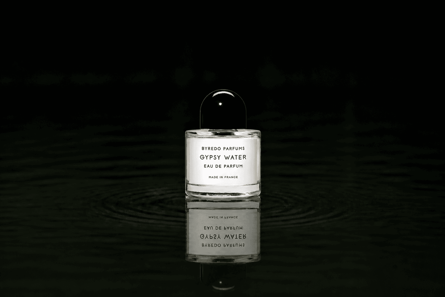 Byredo Parfums - Gypsy Water fragrance bottle floating above dark water