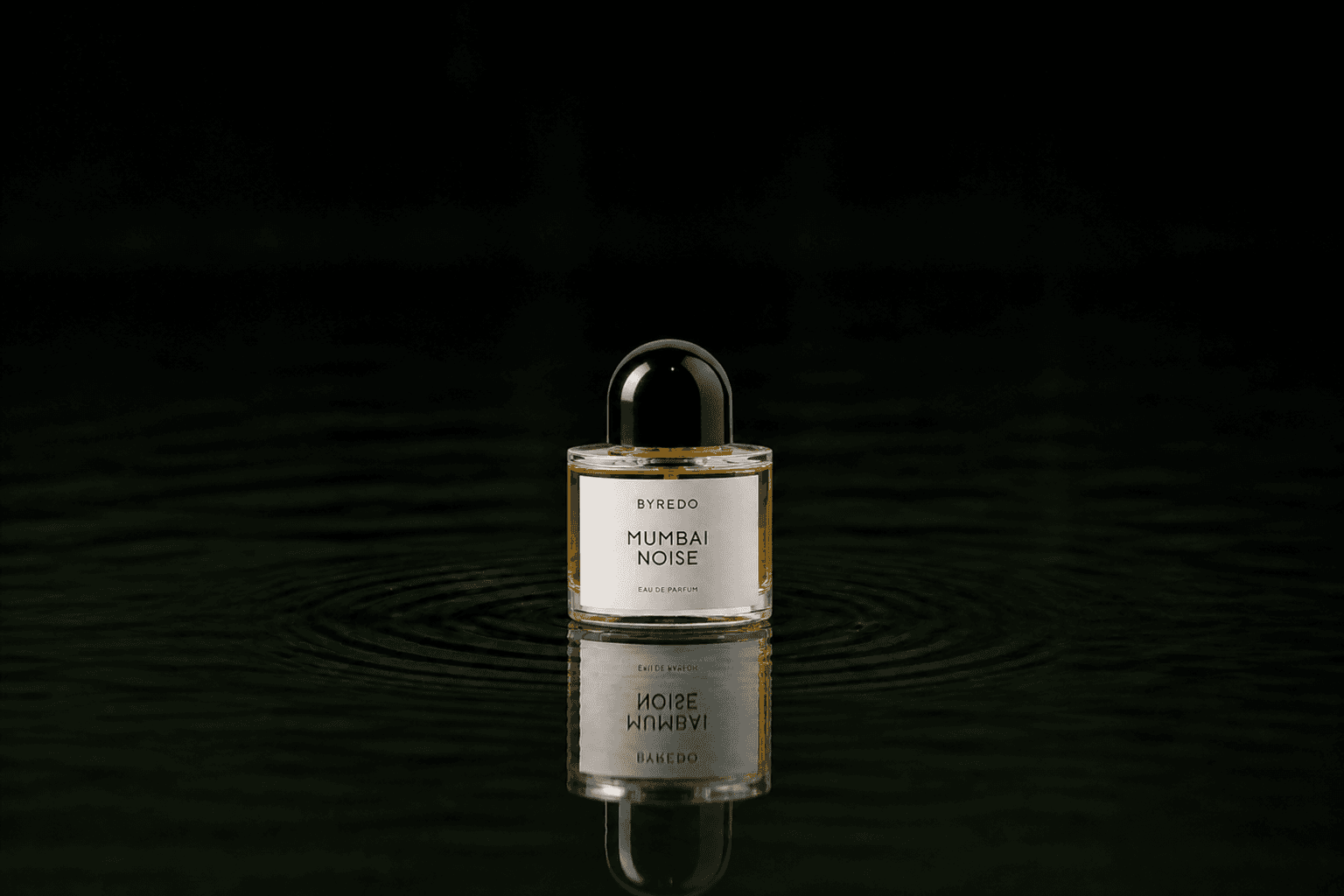 Byredo Parfums - Mumbai Noise fragrance bottle floating above dark water