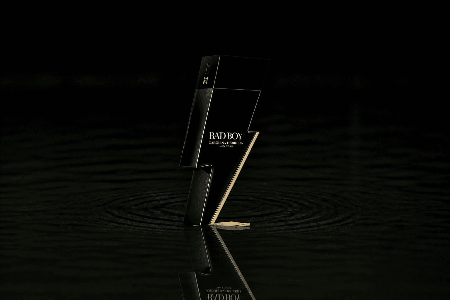 Carolina Herrera Bad Boy fragrance bottle floating above dark water