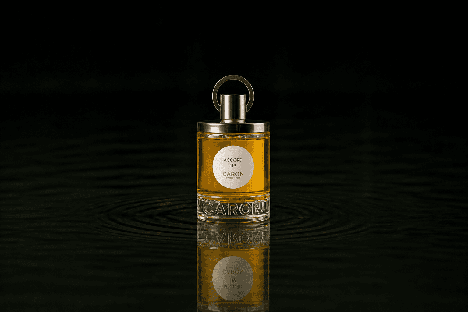 Caron Accord 119 Perfume fragrance bottle floating above dark water