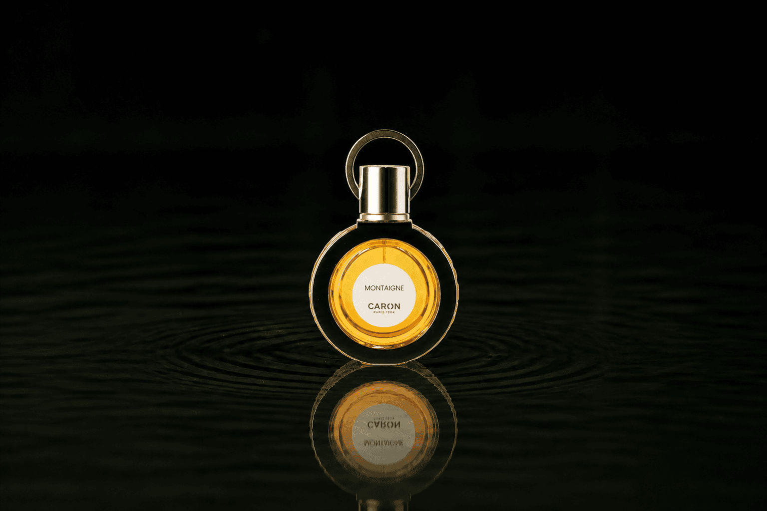 Caron Montaigne Perfume fragrance bottle floating above dark water