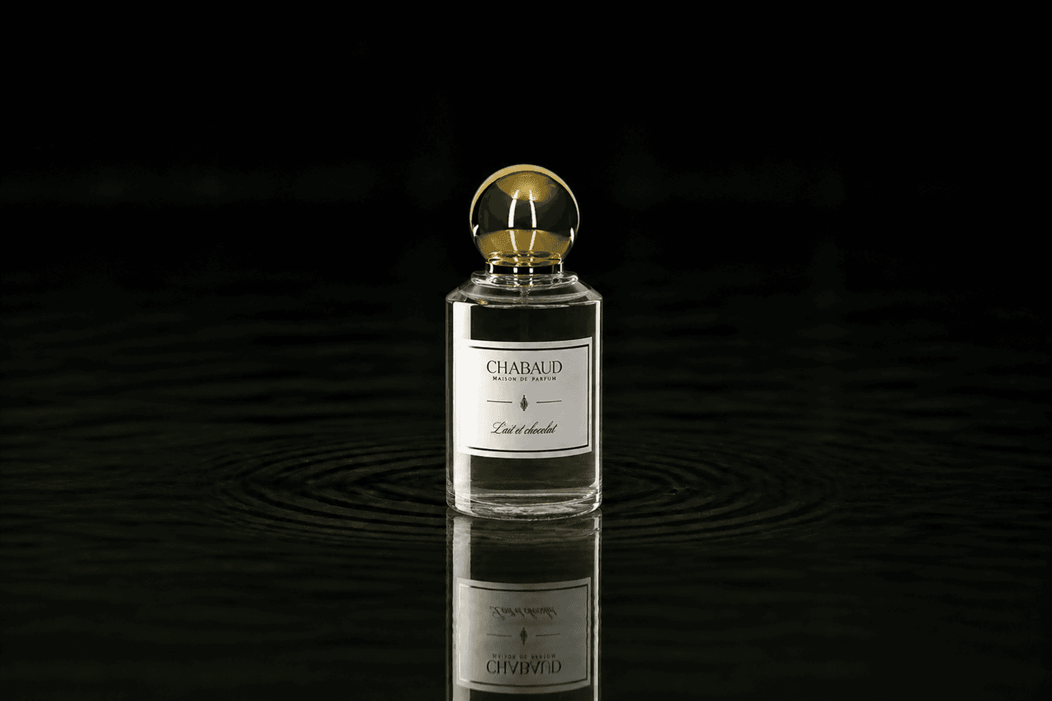 Chabaud Lait Et Chocolat fragrance bottle floating above dark water