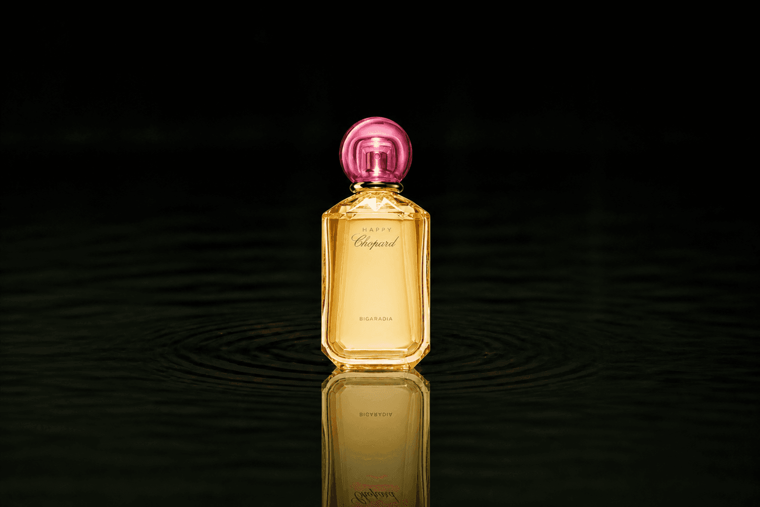 Chopard Happy Chopard - Bigaradia fragrance bottle floating above dark water