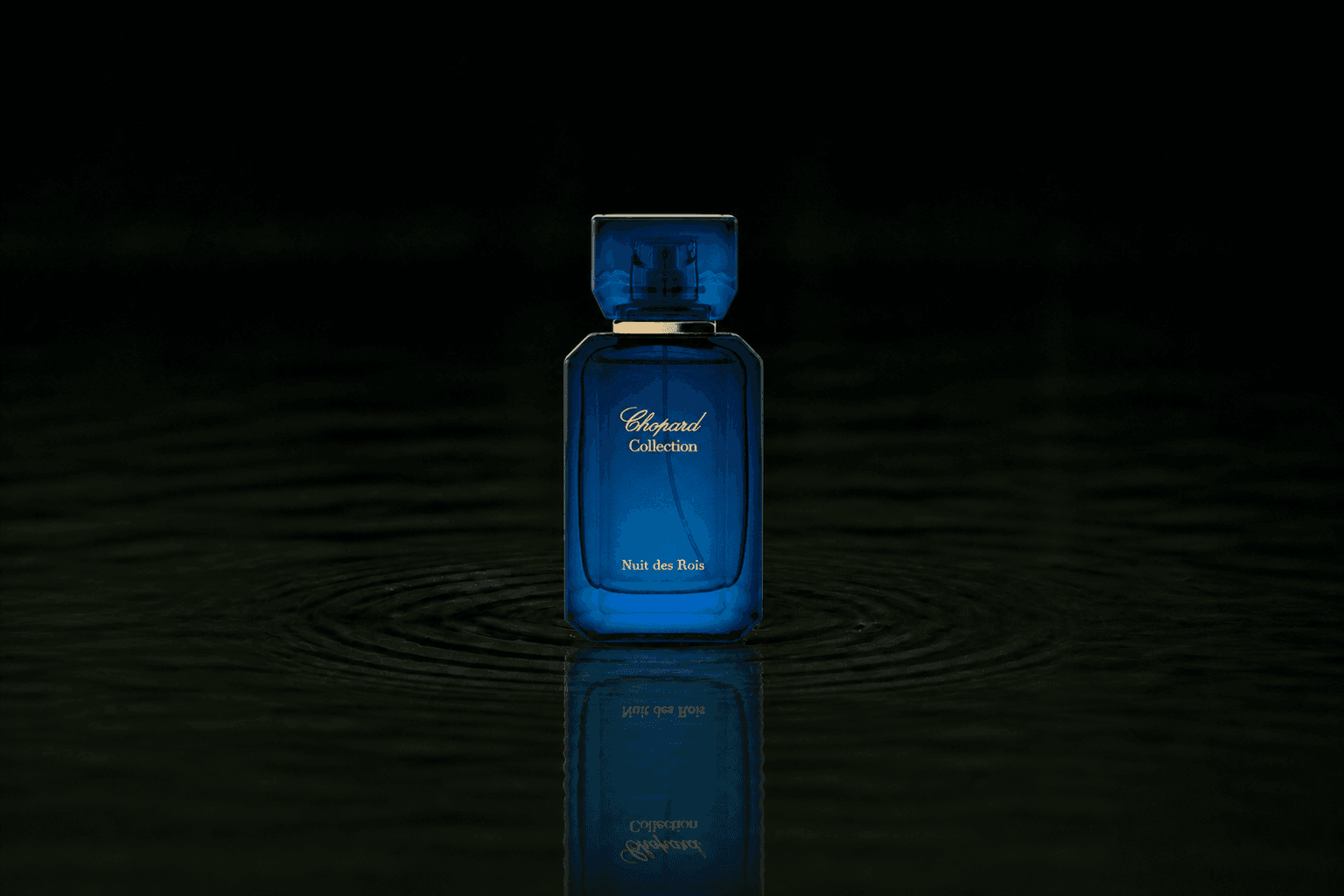 Chopard Nuit Des Rois fragrance bottle floating above dark water