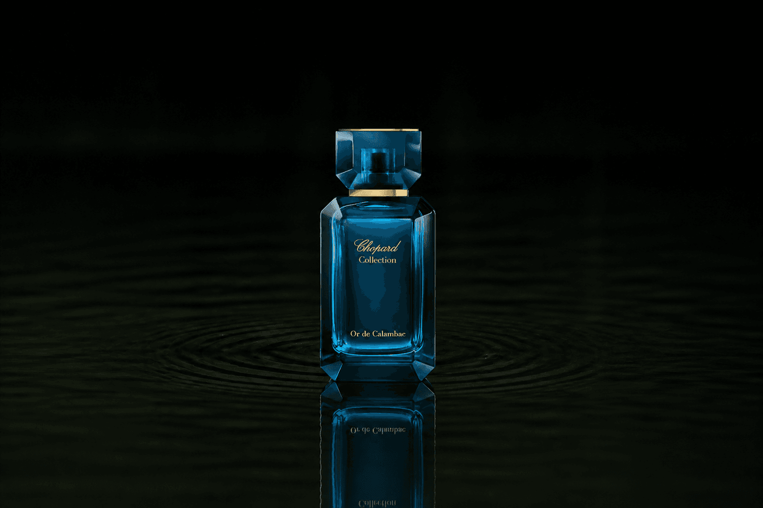 Chopard Or De Calambac Unisex fragrance bottle floating above dark water