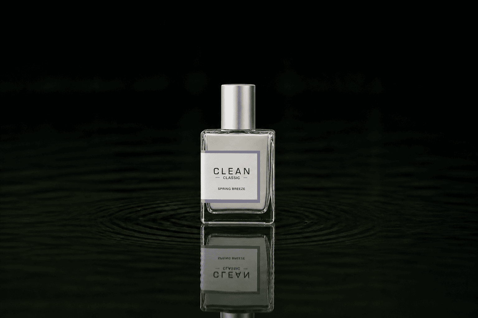 Clean Classic Spring Breeze fragrance bottle floating above dark water
