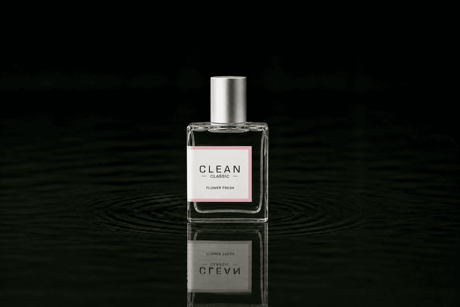 Clean Flower Fresh fragrance bottle floating above dark water