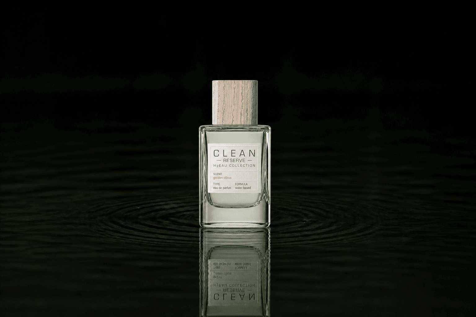 Clean Reserve H2EAU Golden Citrus fragrance bottle floating above dark water