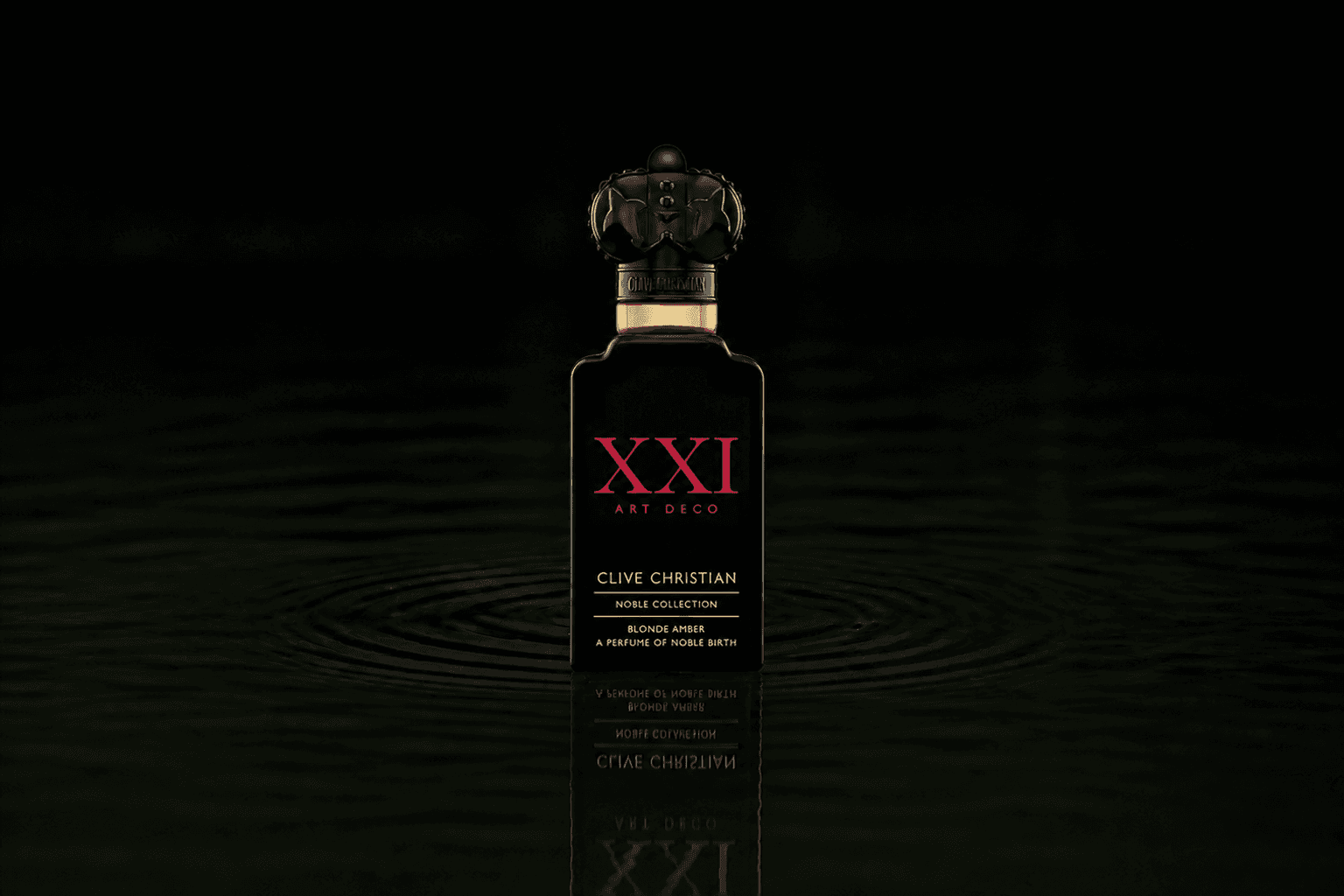 Clive Christian Noble Xxi Art Deco Blonde Amber fragrance bottle floating above dark water