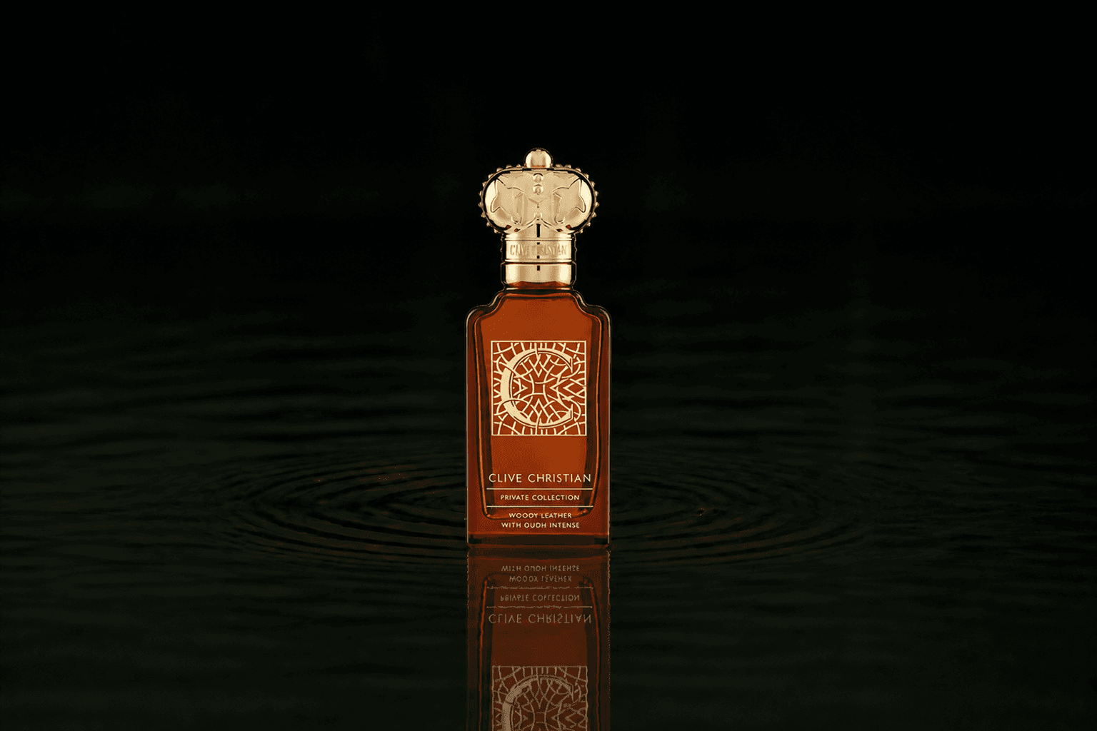Clive Christian Private Collection C Woody Leather fragrance bottle floating above dark water
