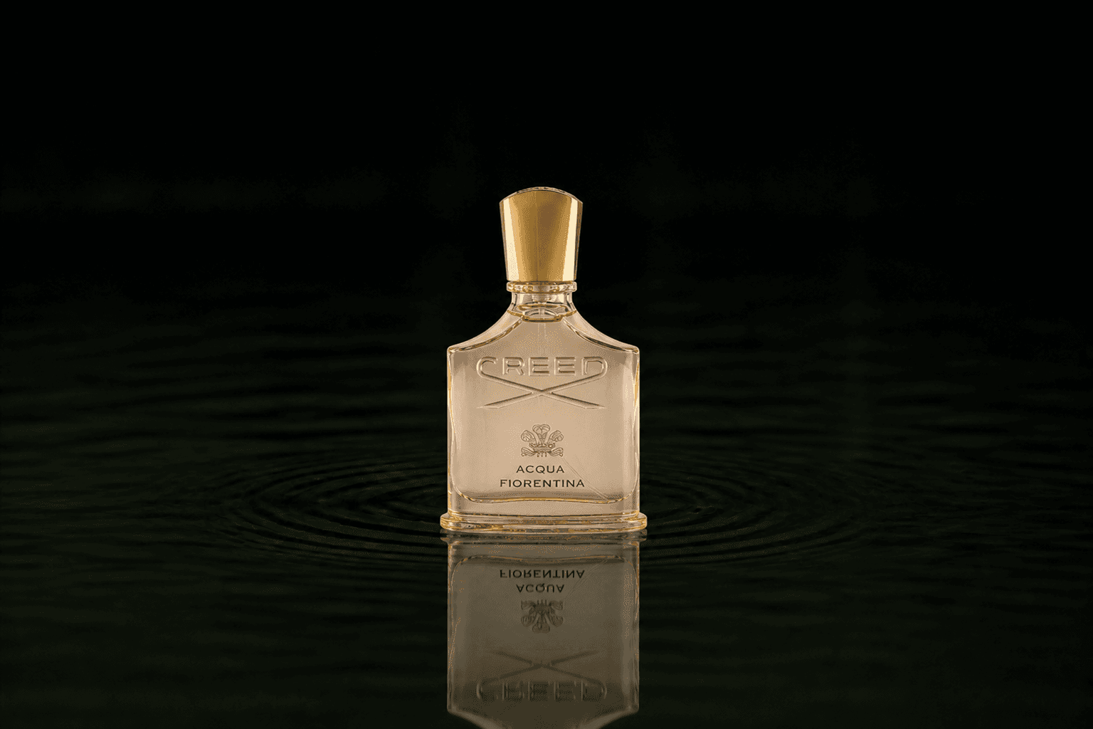 Creed Acqua Fiorentina fragrance bottle floating above dark water