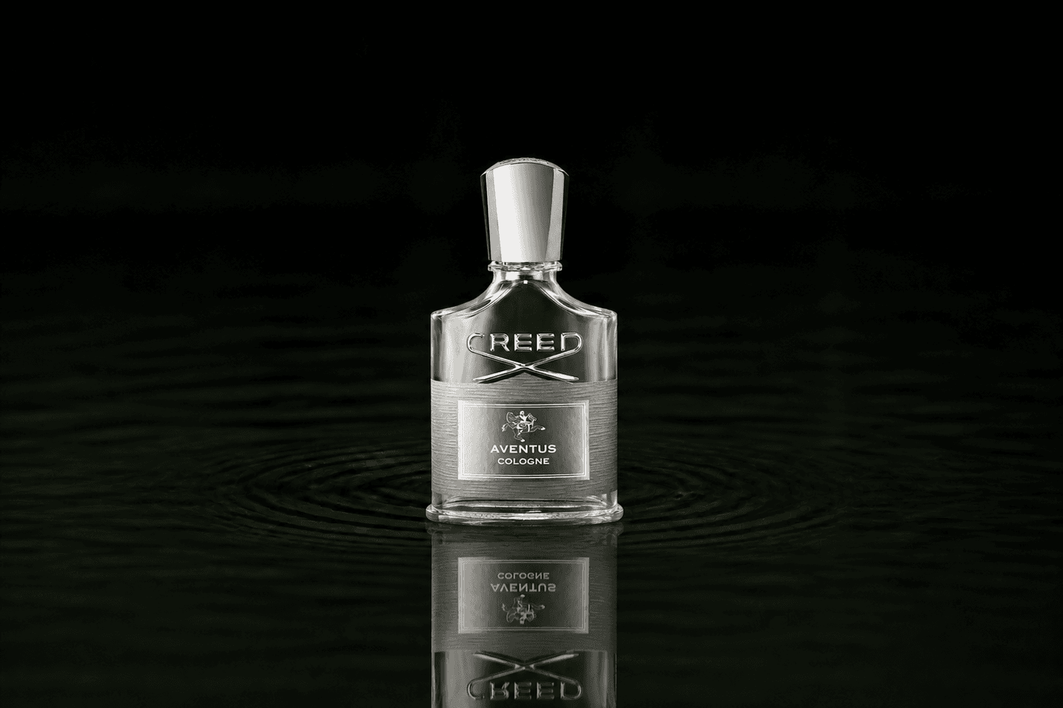Creed Aventus Cologne fragrance bottle floating above dark water