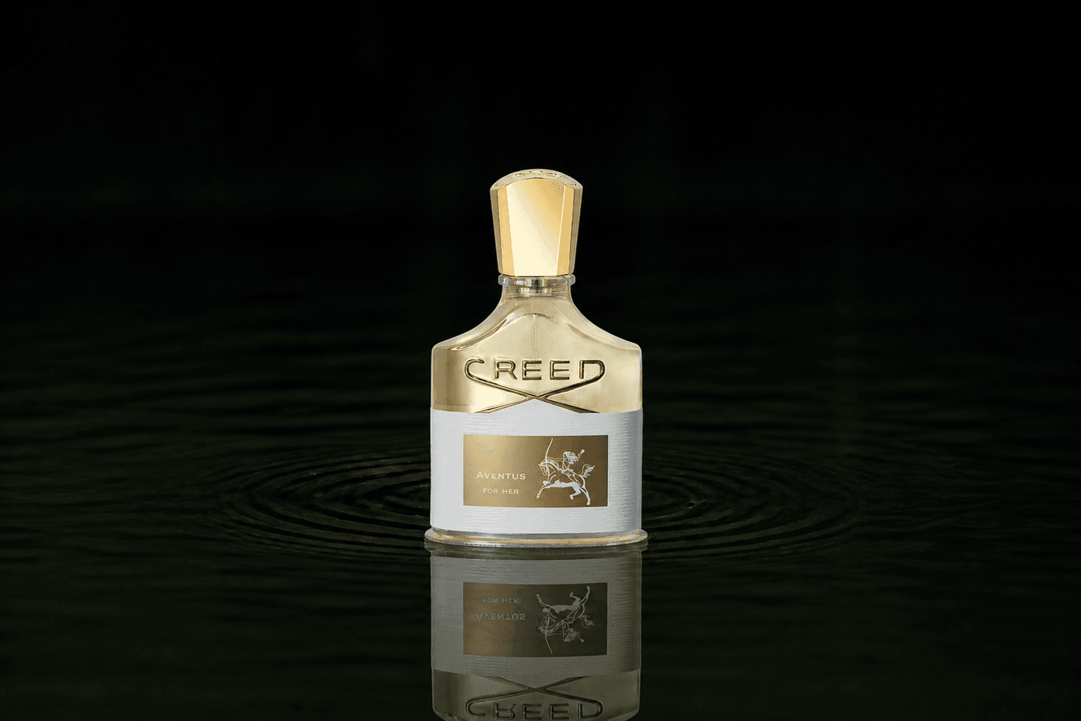 Creed Aventus for Her fragrance bottle floating above dark water