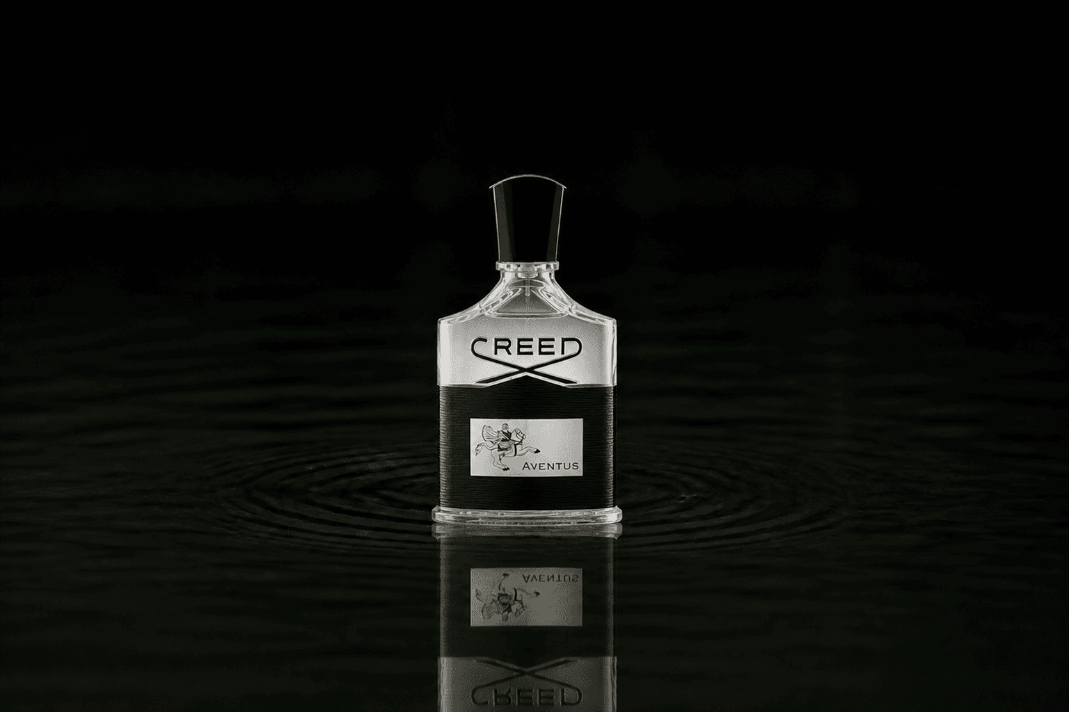 Creed Aventus fragrance bottle floating above dark water