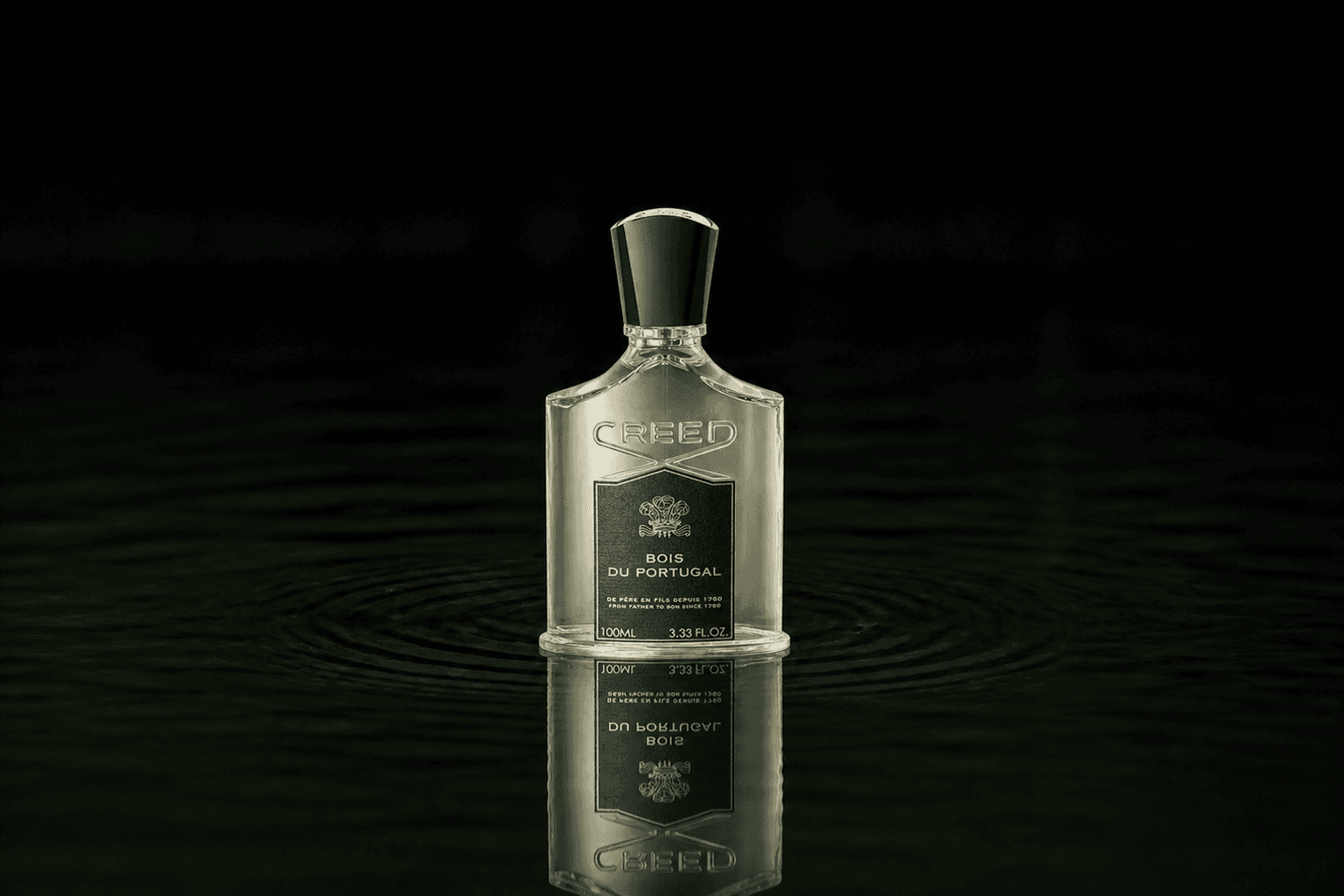 Creed Bois du Portugal fragrance bottle floating above dark water