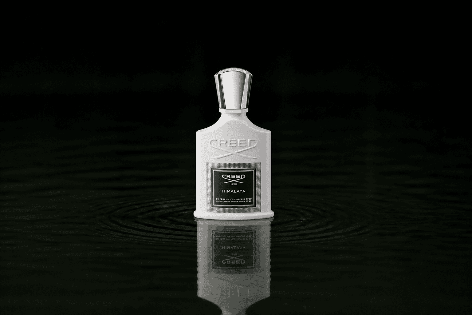 Creed Himalaya fragrance bottle floating above dark water