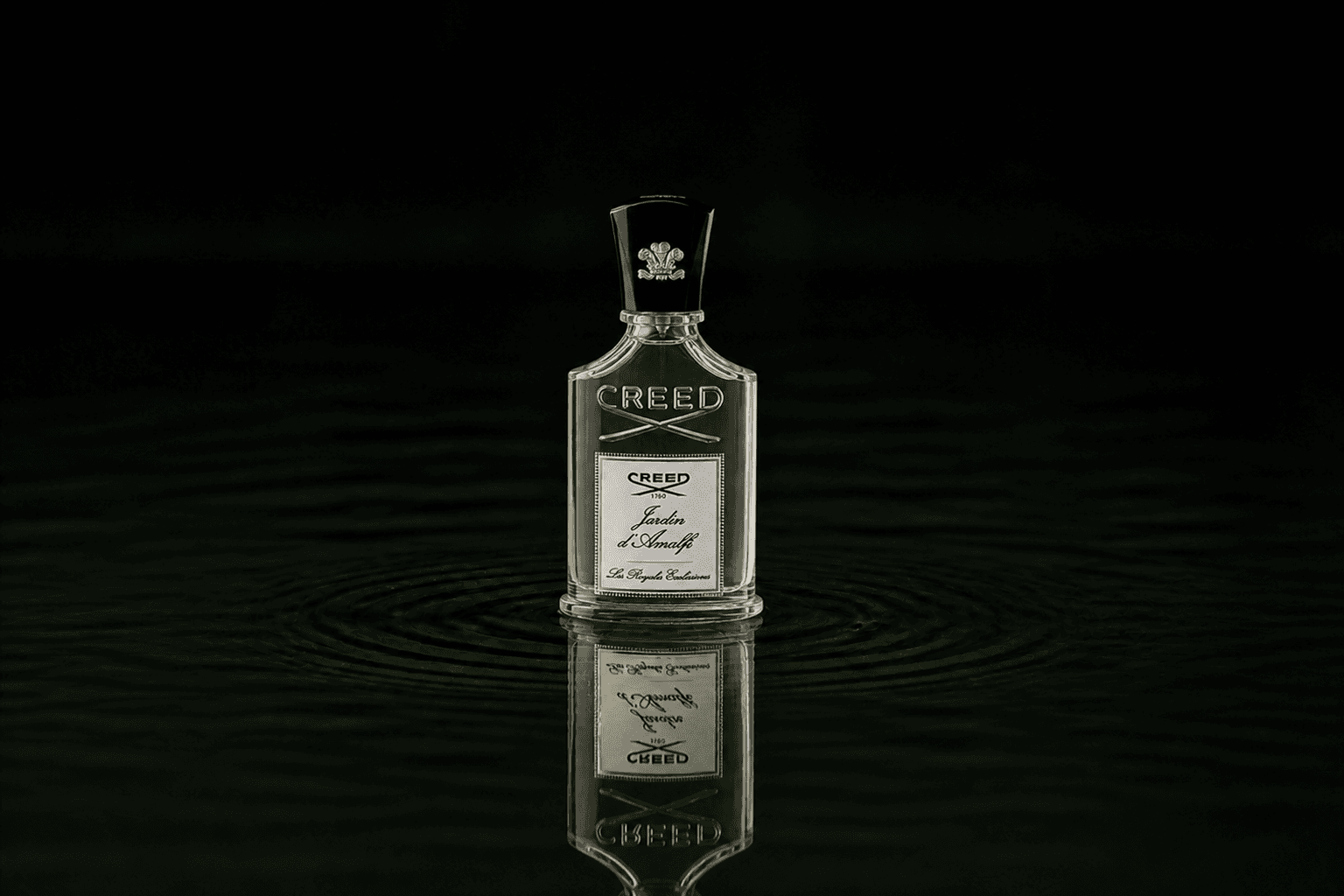 Creed Les Royales Exclusives - Jardin d`Amalfi fragrance bottle floating above dark water