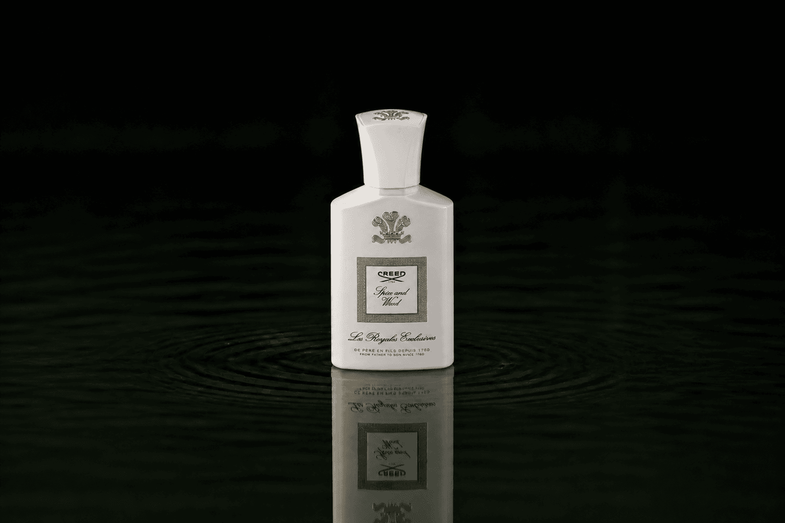 Creed Les Royales Exclusives - Spice and Wood fragrance bottle floating above dark water