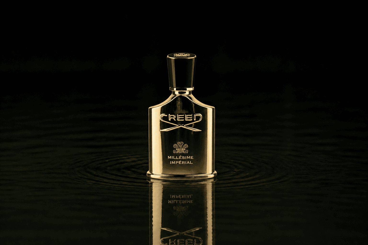 Creed Millesime Imperial fragrance bottle floating above dark water