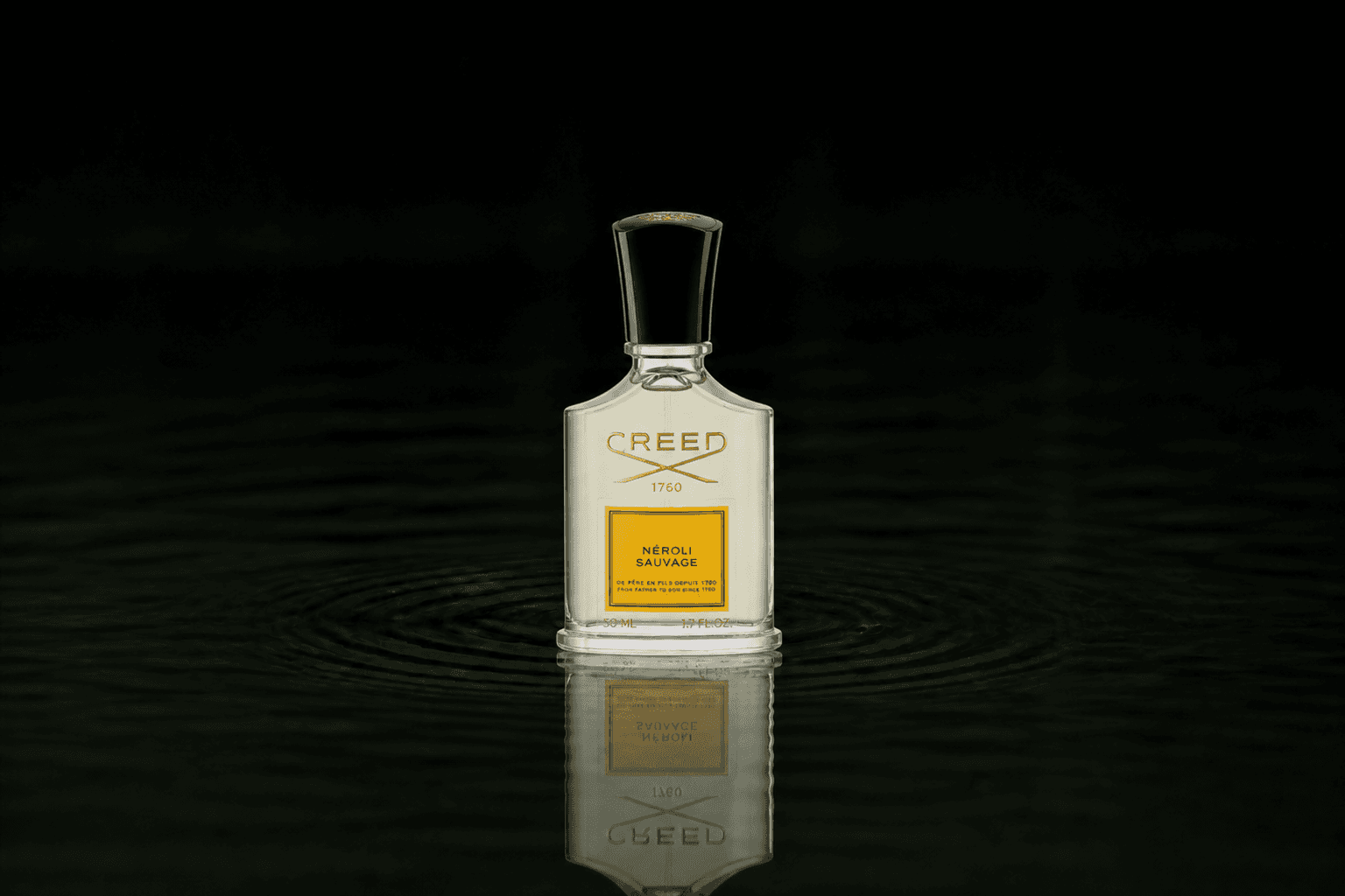 Creed Neroli Sauvage fragrance bottle floating above dark water