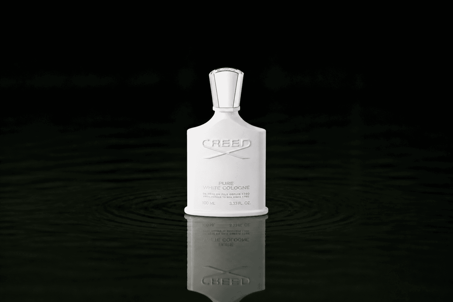 Creed Pure White Cologne fragrance bottle floating above dark water